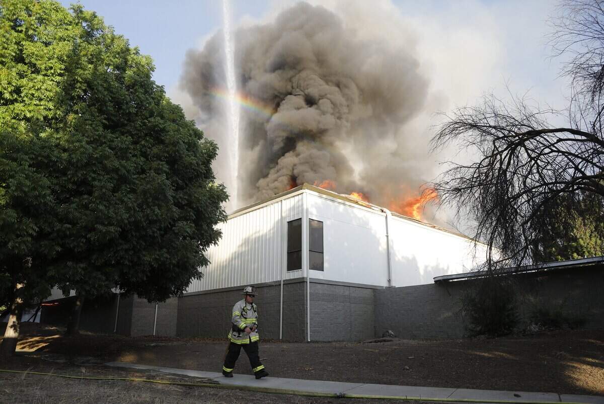 San Jose Fire Department firefighters battle a three-alarm fire at the Public Storage facility at 88 Blossom Hill Road in south San Jose on June 14, 2023.